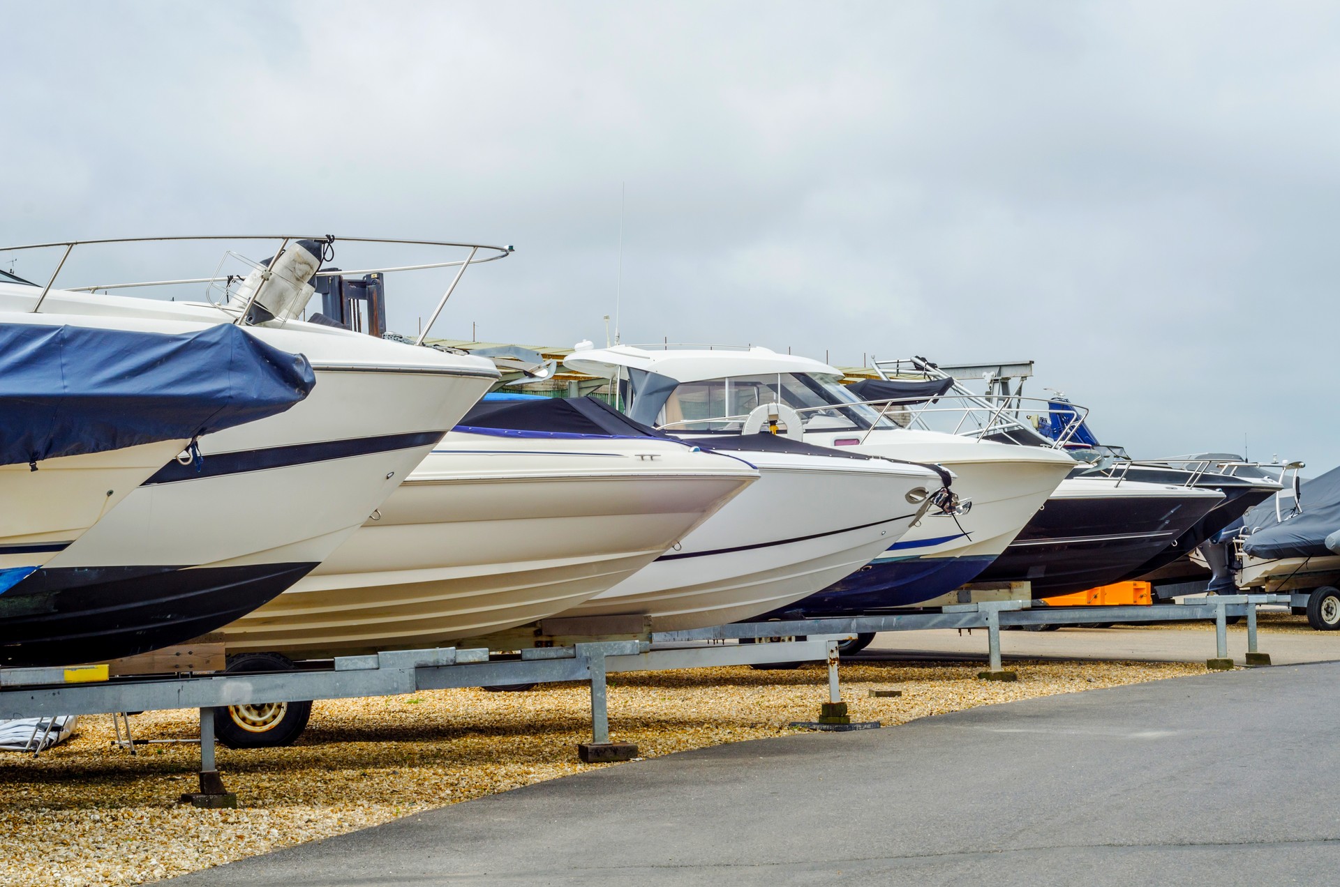 Boat on stand on the shore, close up on the part of the yacht, luxury ship, maintenance and parking place boat,